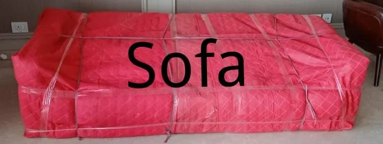 Sofa wrapped in quilted padding for furniture shifting